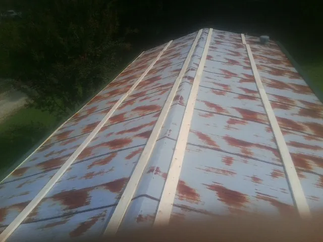Rusted metal roof panels with new wood purlins before replacement — Storm Damage Roof Repair in Blakely Island by Roofing Brothers